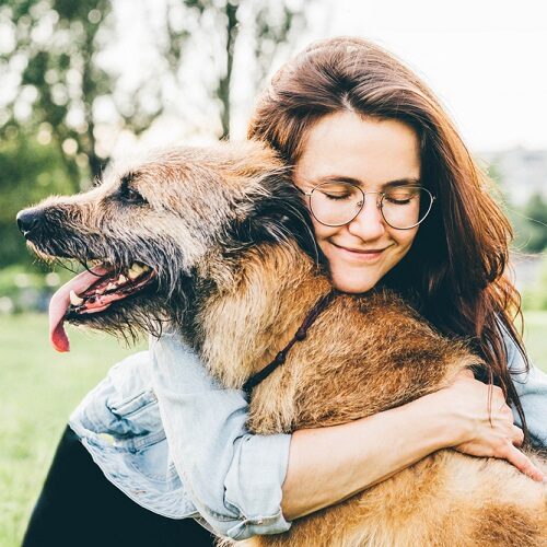 Woman hugging a senior dog
